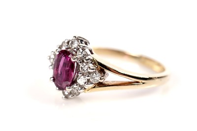 Lot 656 - A ruby and diamond cluster ring