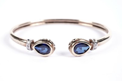 Lot 541 - A sapphire and diamond torque bangle