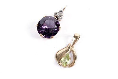 Lot 554 - A colour-change sapphire and diamond pendant; and a peridot pendant