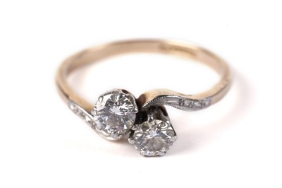 Lot 562 - A two-stone diamond crossover pattern ring