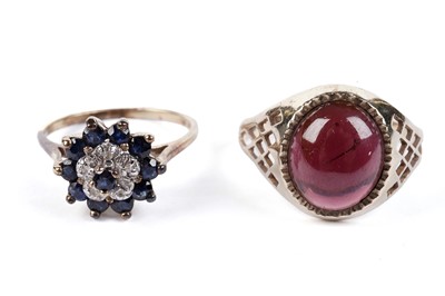 Lot 637 - A garnet cabochon ring; and a sapphire and diamond cluster ring