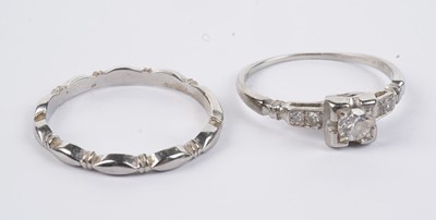 Lot 626 - A diamond solitaire ring; and a wedding band