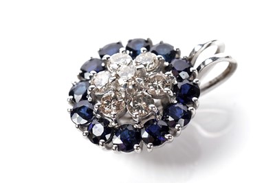 Lot 1249 - A sapphire and diamond cluster pendant