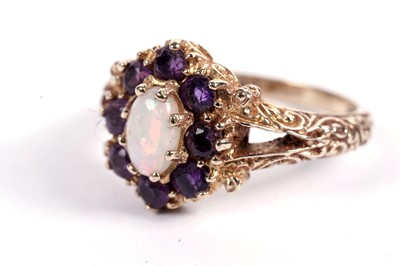 Lot 582 - An amethyst and opal dress ring of antique style