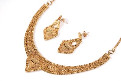 Lot 1255 - An Indian high carat yellow gold necklace and matching earrings