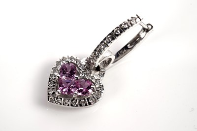 Lot 1259 - A pink sapphire and diamond ring and matching earrings
