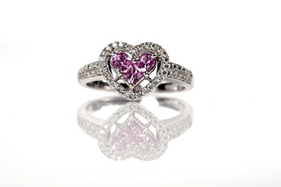 Lot 1259 - A pink sapphire and diamond ring and matching earrings