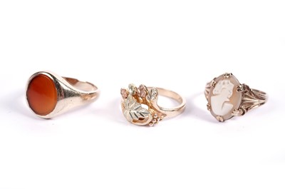 Lot 505 - A 9ct gold cameo ring; a 9ct gold carnelian ring; and one other leaf pattern ring