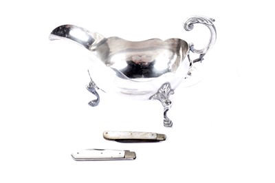 Lot 950A - An Elizabeth II Britannia standard silver sauce boat; and two fruit knives