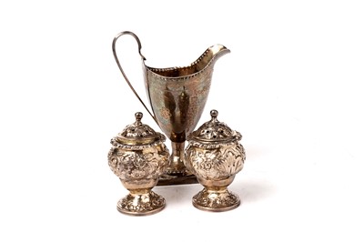 Lot 1526 - A George III silver helmet cream jug; and pair of silver pepper casters