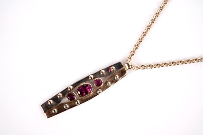 Lot 1087 - A ruby pendant and earrings