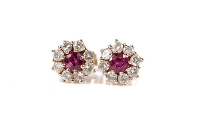 Lot 1088 - A pair of ruby and diamond cluster earrings