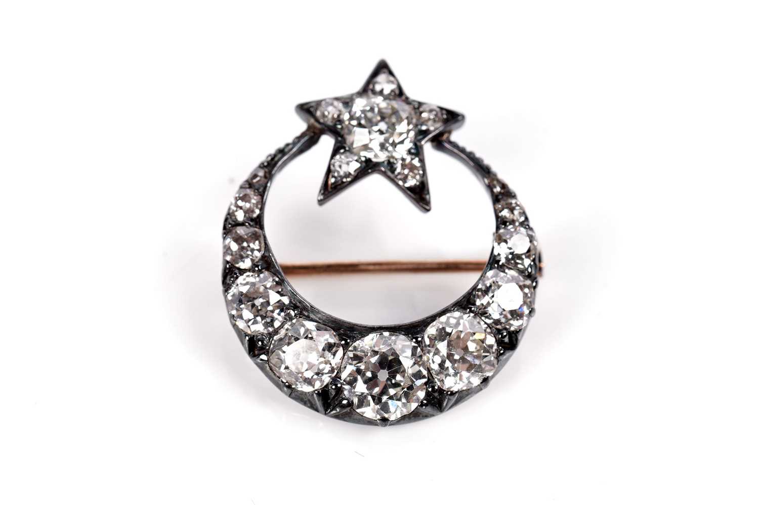 Lot 1265 - A Victorian diamond crescent and star brooch