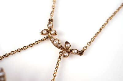 Lot 1091 - An Edwardian peridot and seed pearl pendant necklace with brooch fitting