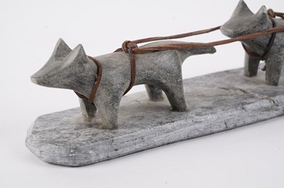 Lot 1504 - A 20th Century Inuit stone carving of a figure on dog sled