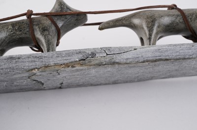 Lot 1504 - A 20th Century Inuit stone carving of a figure on dog sled