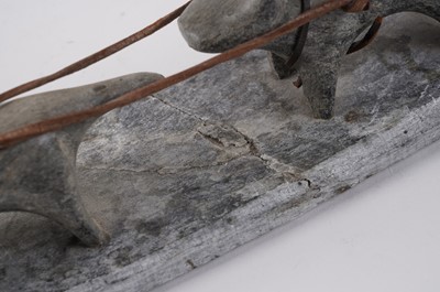 Lot 1504 - A 20th Century Inuit stone carving of a figure on dog sled