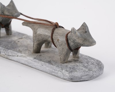 Lot 1504 - A 20th Century Inuit stone carving of a figure on dog sled