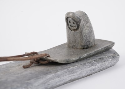 Lot 1504 - A 20th Century Inuit stone carving of a figure on dog sled