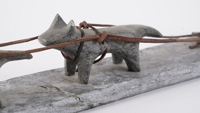Lot 1504 - A 20th Century Inuit stone carving of a figure on dog sled