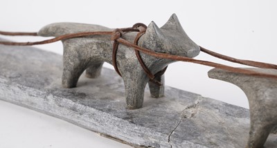 Lot 1504 - A 20th Century Inuit stone carving of a figure on dog sled