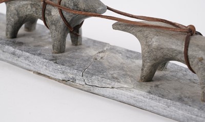 Lot 1504 - A 20th Century Inuit stone carving of a figure on dog sled