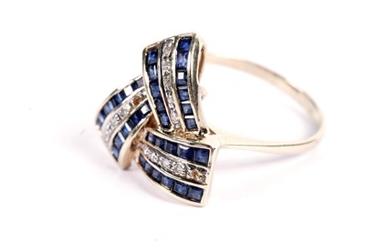 Lot 506 - A sapphire and diamond ribbon pattern dress ring