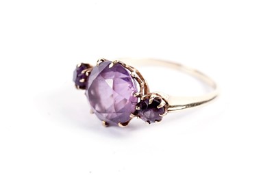 Lot 521 - A three-stone amethyst ring