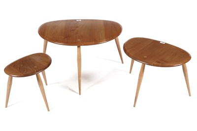 Lot 765 - An Ercol model 354 ‘Pebble’ nest of three elm topped tables