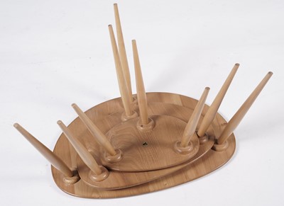 Lot 765 - An Ercol model 354 ‘Pebble’ nest of three elm topped tables