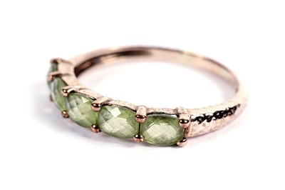 Lot 428 - A five-stone peridot ring