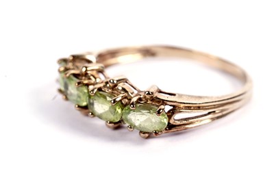 Lot 429 - A four-stone peridot ring