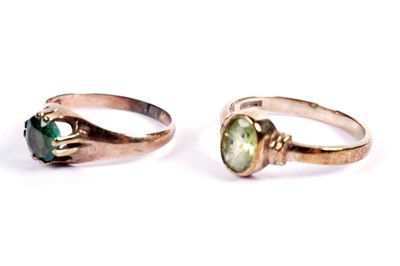 Lot 434 - A single-stone peridot ring; and an emerald ring