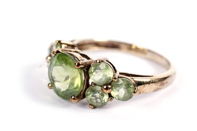 Lot 443 - A seven-stone peridot dress ring