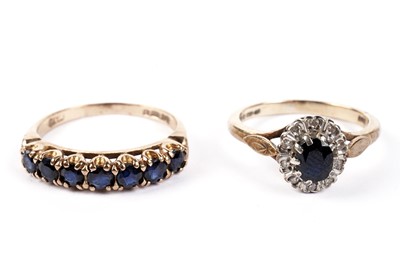 Lot 462 - A seven-stone sapphire ring; and a sapphire and diamond cluster ring