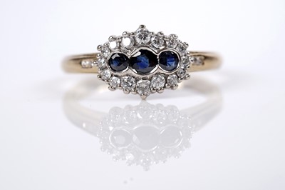 Lot 1233 - A sapphire and diamond cluster ring