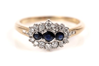 Lot 1233 - A sapphire and diamond cluster ring