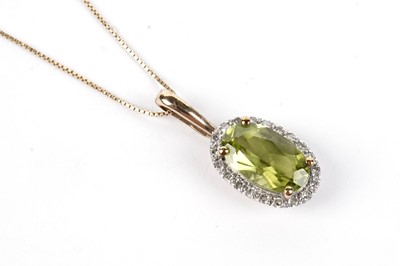 Lot 485 - A peridot and diamond cluster pendant