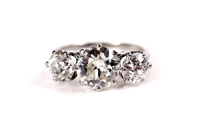 Lot 1285 - A three stone old-European cut diamond ring