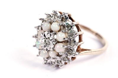 Lot 69 - An opal and diamond cluster dress ring