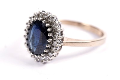 Lot 594 - A sapphire and diamond cluster ring