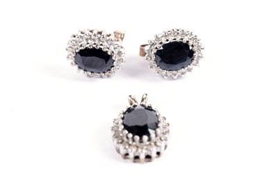 Lot 595 - A pair of sapphire and diamond cluster earrings and pendant