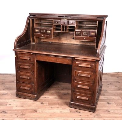 Lot 24 - An early 20th Century oak roll-top desk