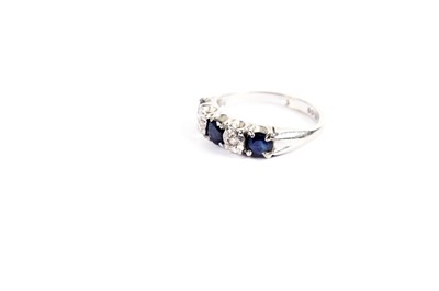 Lot 720 - A sapphire and diamond half hoop eternity ring