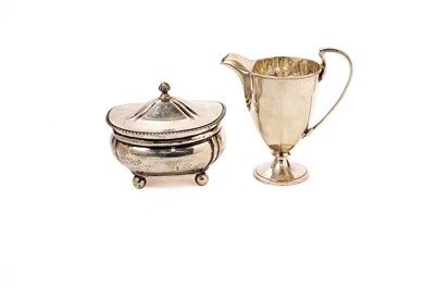 Lot 829 - A silver helmet form cream jug; and silver covered box