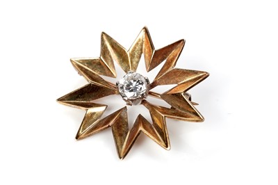 Lot 1111 - A diamond and gold star pattern brooch