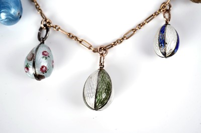 Lot 1297 - Faberge interest: an Easter egg pendant necklace; and two loose eggs