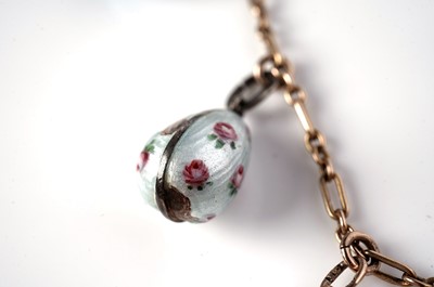 Lot 1297 - Faberge interest: an Easter egg pendant necklace; and two loose eggs