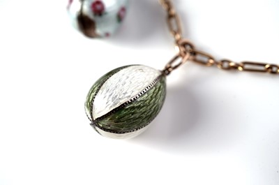 Lot 1297 - Faberge interest: an Easter egg pendant necklace; and two loose eggs