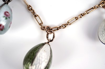 Lot 1297 - Faberge interest: an Easter egg pendant necklace; and two loose eggs